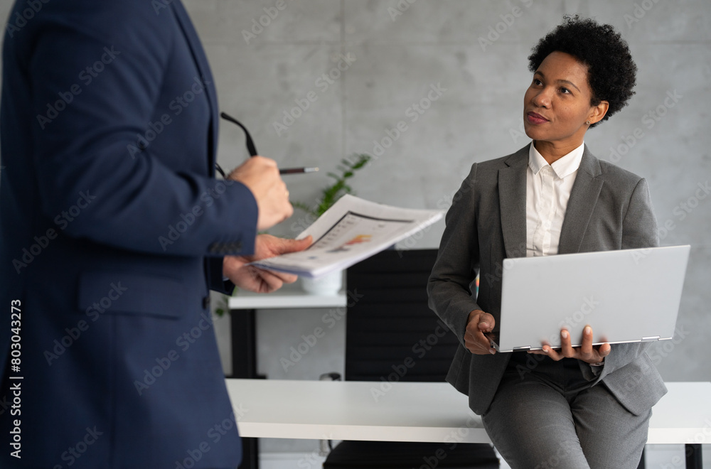 Afro American businesswoman talking with colleagues Afro American businesswoman talking with colleagues