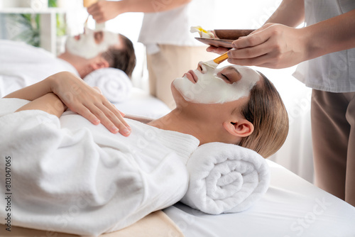 Serene ambiance of spa salon  couple indulges in rejuvenating with luxurious face cream massage with modern daylight. Facial skin treatment and beauty care concept. Quiescent