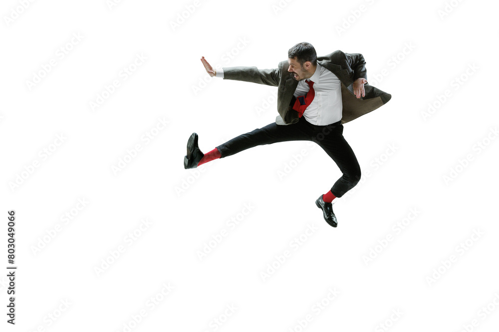Rejecting new rules. Employee on formalwear jumping in dynamic pose with angry face isolated on transparent background. Concept of human emotions, employment, business, stress, mental health Rejecting new rules. Employee on formalwear jumping in dynamic pose with angry face isolated on transparent background. Concept of human emotions, employment, business, stress, mental health