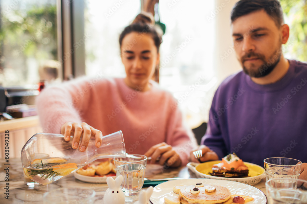 Group of millennial friends having breakfast together in a coffeeshop.