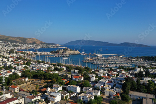 Bodrum city aerial shot. Aegean sea, traditional white houses, flowers, marina, sailing boats, yachts in Bodrum town Turkey.  © yusuf