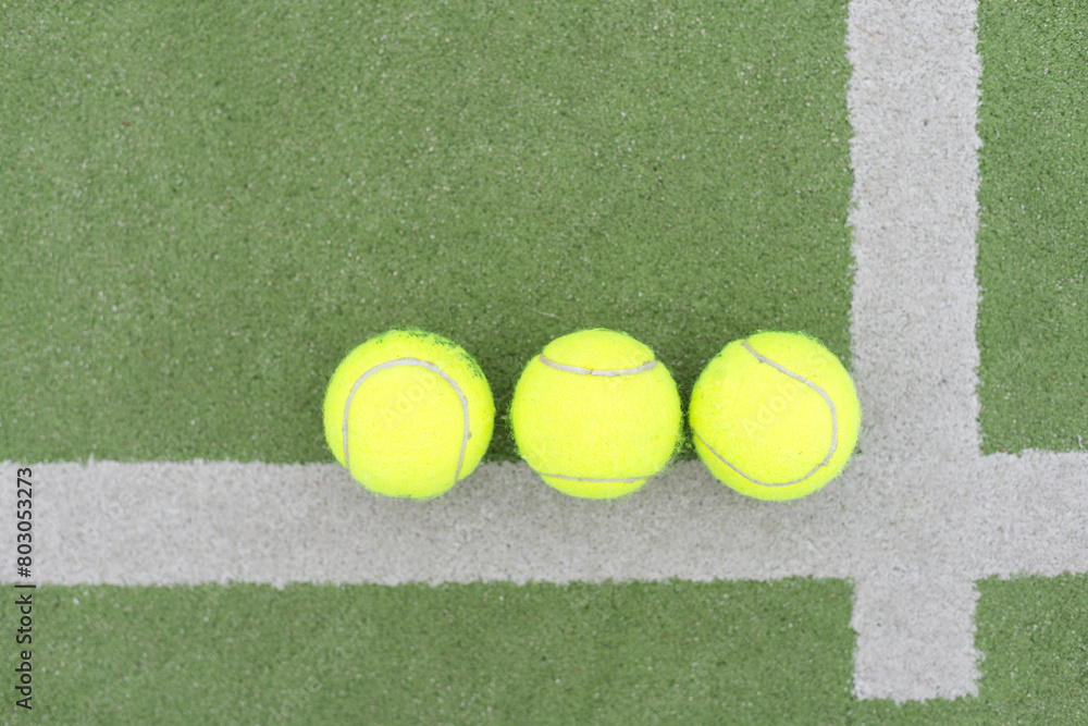 close up of a padel and tennis court with artificial grass and balls