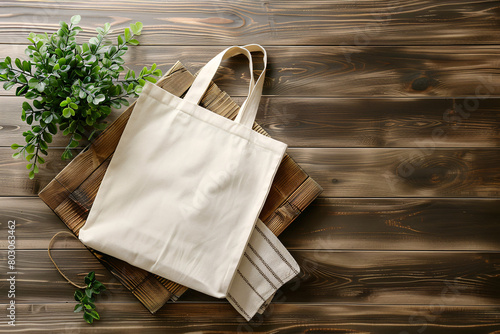 Canvas tote bag on wooden surface with green plant, eco-friendly, reusable photo
