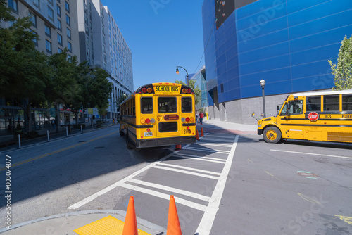 Bright yellow school bus on busy Georgia Aquarium Street