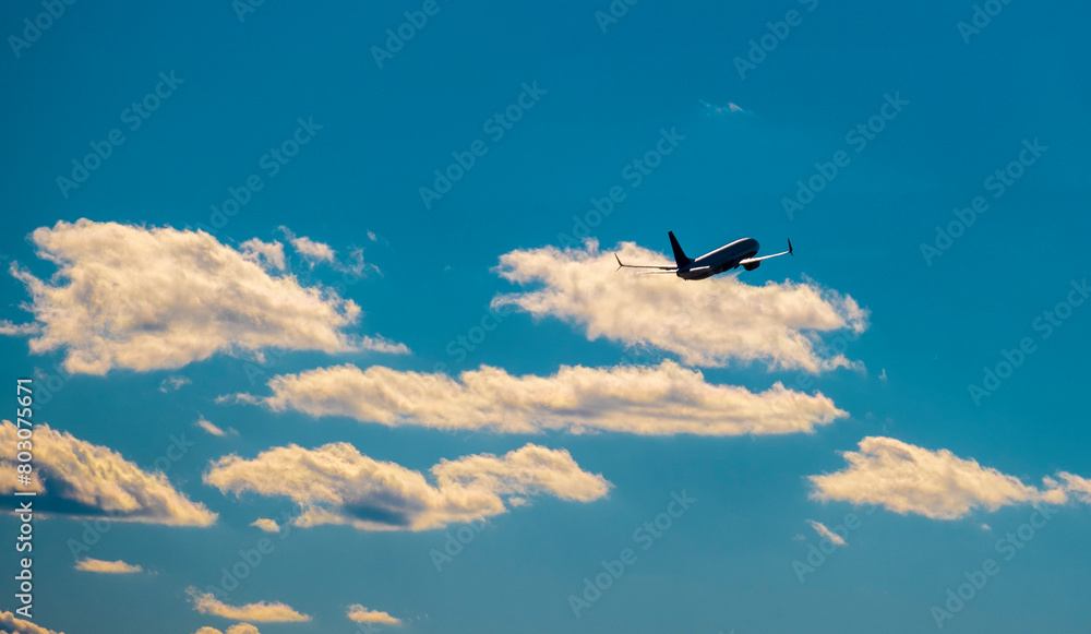 Airplane taking off in blue sky with some clouds Airplane taking off in blue sky with some clouds