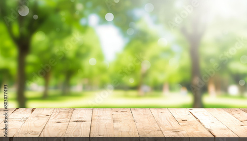 Nature background, Wood table for food and product display over blur green tree garden, Blur park nature outdoor and wood table with bokeh light background in spring and summer photo