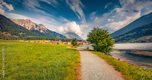 Tourist path to St. Valentin village. Impressive morning view of Muta lake (Haidersee), South Tyrol, Italy, Europe. Traveling concept background.