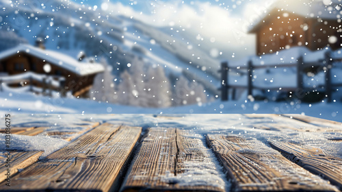 Empty wooden table at snowy ski resort on winter day -