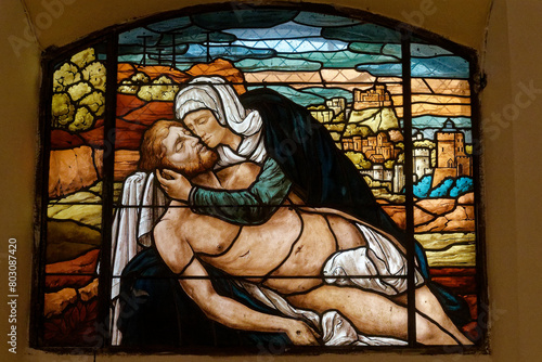 A stained-glass window depicting the Pieta. Un vitrail représentant la Piéta. Mouxy - France 