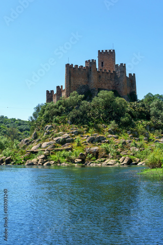 almoural castle portugal viewed from the riverbank exterior building view over riverbank