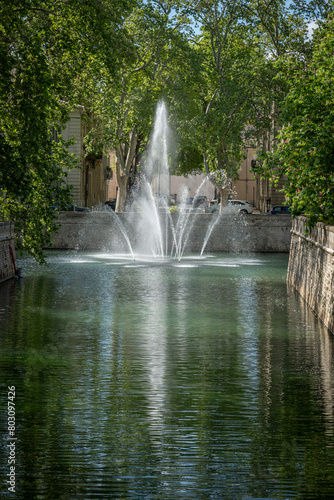 N  mes  France - 04 17 2024  The Gardens of The Fountain. View of water jets from the fountain quay.