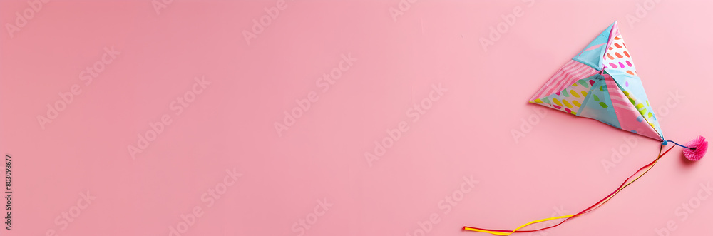 Patterned beach kite web banner. Patterned beach kite isolated on pink background with copy space.