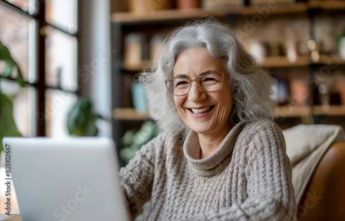 Joyful senior woman using laptop. Perfect for illustrating happiness, aging, and digital literacy. Great for tech, education, and senior lifestyle sectors.