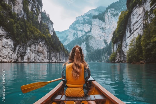Adventure: Woman Rowing in Scenic Mountain Lake, Nature, Travel, Canoe, Solitude © Bernardo
