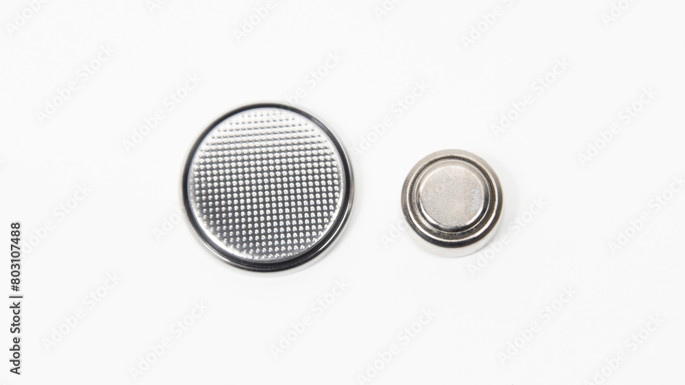 LR44 and CR2032 button cell batteries on a white background. Close up. LR44 and CR2032 button cell batteries on a white background. Close up.