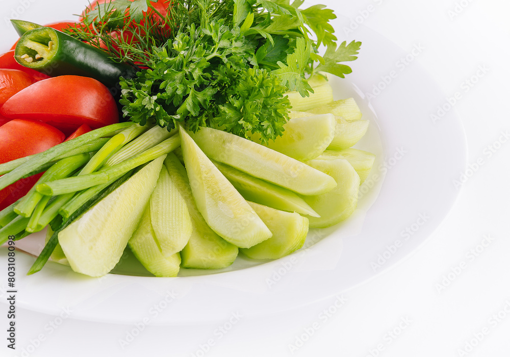 Vegan plate of fresh sliced cucumbers, green onions and cherry tomatoes Vegan plate of fresh sliced cucumbers, green onions and cherry tomatoes