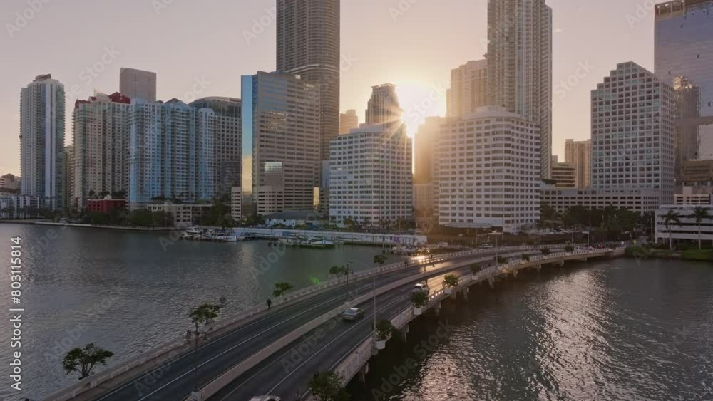 Miami Brickell Key. Miami USA downtown. Aerial view of cars driving on the bridge towards Miami downtown Brickell Key Skyline at sunset Miami Brickell Key. Miami USA downtown. Aerial view of cars driving on the bridge towards Miami downtown Brickell Key Skyline at sunset
