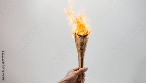 human hand holding the burning Olympic torch, isolated white background 
