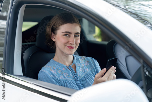 Beautiful woman in casual wear sitting on driver seat portrait. Cute girl driving a car concept with happy expression and pleasant smiling. Young woman with car road trip lifestyle. Perpetual © Summit Art Creations