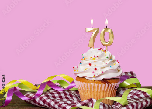 Birthday Cake With Candles Lit Forming The Number 70