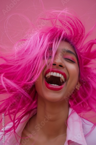 Joyful Indian woman with vibrant pink hair laughing heartily