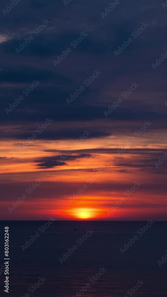 Vertical video - Timelapse of the Sun setting on the ocean Vertical video - Timelapse of the Sun setting on the ocean