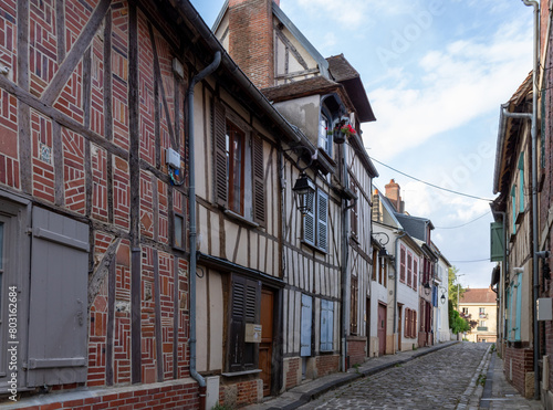 Beautiful street with traditional French buildings with wooden beams and colorful, surroundings of La Cathédrale Saint-Pierre, Beauvais, France.