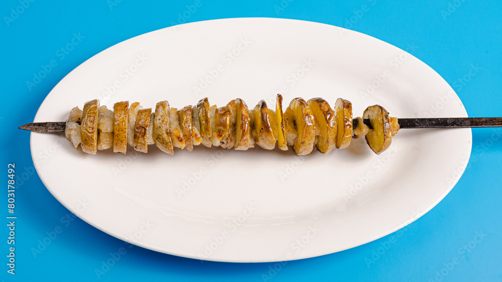 Potato and lamb fat kebab skewers on plate top view Potato and lamb fat kebab skewers on plate top view