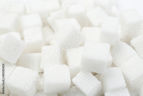 Many refined white sugar cubes, closeup view