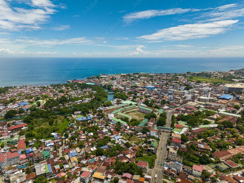 Panorama drone view of Iligan City. Blue sky and clouds. Northern Mindanao, Philippines.