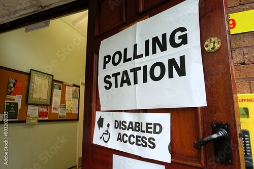 UK polling station sign on the door of a village hall