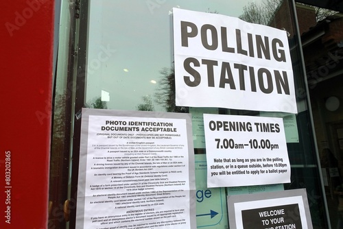 UK polling station signs including opening times and photo identification documents acceptable