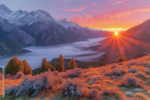 The setting sun casts a golden glow on the mountain peaks and the valley below