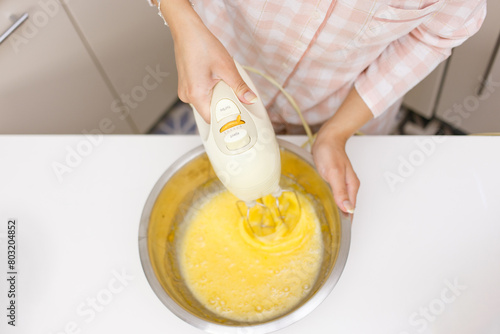 Young girl is cooking breakfast in the kitchen