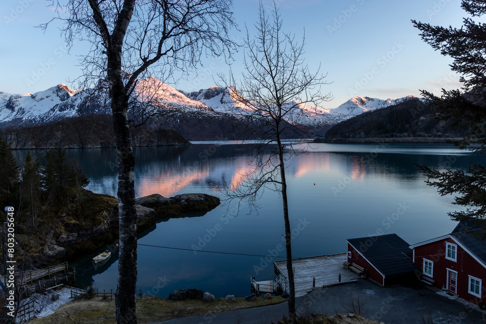 cabin by the Holandsfjord in Nordland county.In the background is the Svartisen glacier, Norway's second largest glacier