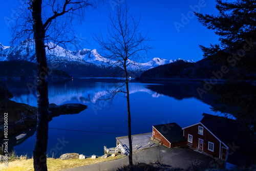 Obraz na płótnie night shot of cabin by the Holandsfjord in Nordland county.In the background is the Svartisen glacier, Norway's second largest glacier w salonie