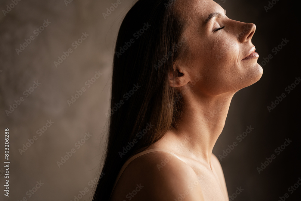 Profile side photo of stunning dreamy lady natural cosmetics mo filter fresh skin empty space isolated on grey concrete wall background Profile side photo of stunning dreamy lady natural cosmetics mo filter fresh skin empty space isolated on grey concrete wall background