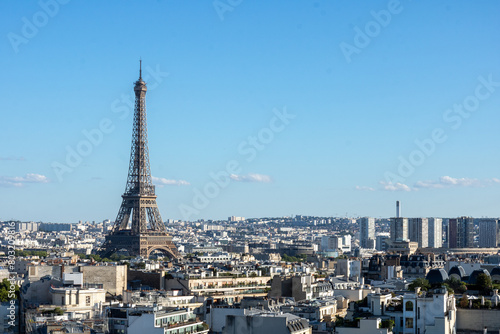 Fototapeta Naklejka Na Ścianę i Meble -  Panoramic view of the Eiffel tower, on the Parisian buildings in the center,  Arc de Triomphe de l'Étoile, located on the Charles de Gaulle square, and at the western end of the Champs Elysées avenue 