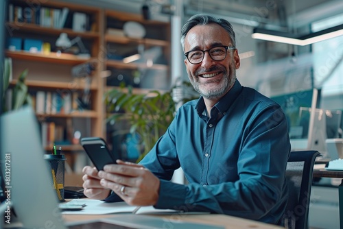 Smiling mature businessman in eyeglasses using mobile phone while working in office, AI Generated