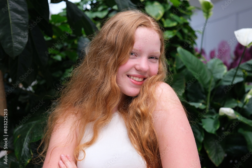 Satisfied, beautiful happy red-haired girl smiling, leaning against her shoulder Satisfied, beautiful happy red-haired girl smiling, leaning against her shoulder