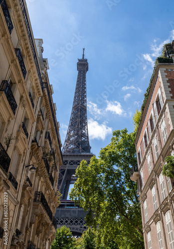 Eiffel tower, close up view from Rue de l'Université, surrounded by traditional French buildings, in the city of Paris, France. © MARIA ALBI