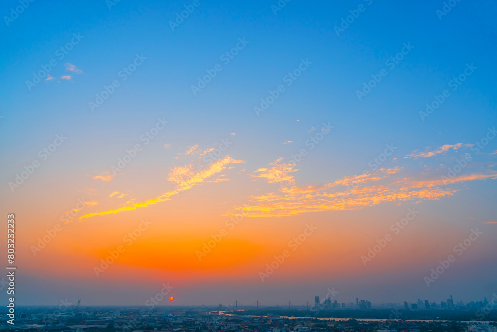 Yellow blue orange gradient with clouds over the city