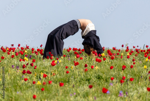 A girl makes a cartoon in a tulip field