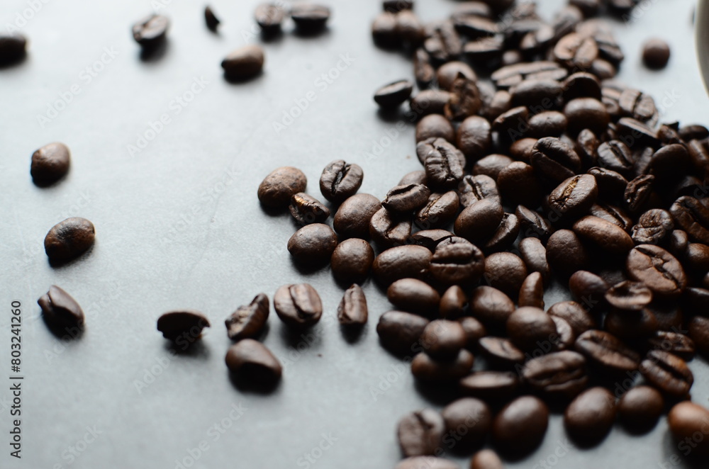 Naklejka premium coffee beans on a wooden grey background
