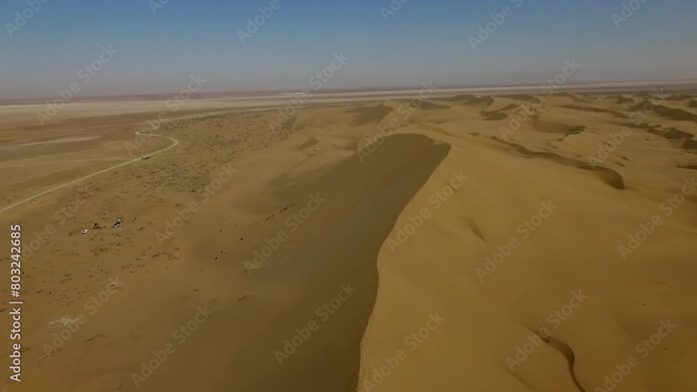 People having fun in desert on sand dunes. Off-road riding. camels. climbing. High resolution and quality aerial footage. People having fun in desert on sand dunes. Off-road riding. camels. climbing. High resolution and quality aerial footage.