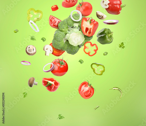Different fresh vegetables in air on green background