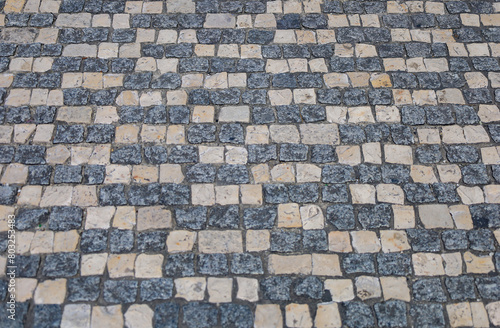 Calçada portuguesa, imagem de fundo de pedras prestas e brancas photo