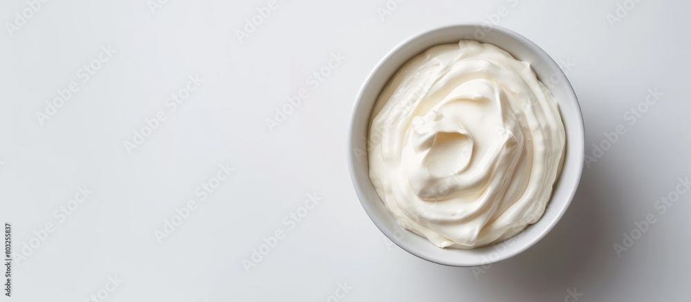 A bowl of Greek-styled sour cream on a white background A bowl of Greek-styled sour cream on a white background