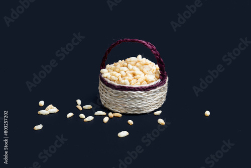 Puffed rice in a jute basket isolated on black background. photo