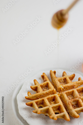 Waffle with honey. Aesthetic composition. Food Styling.